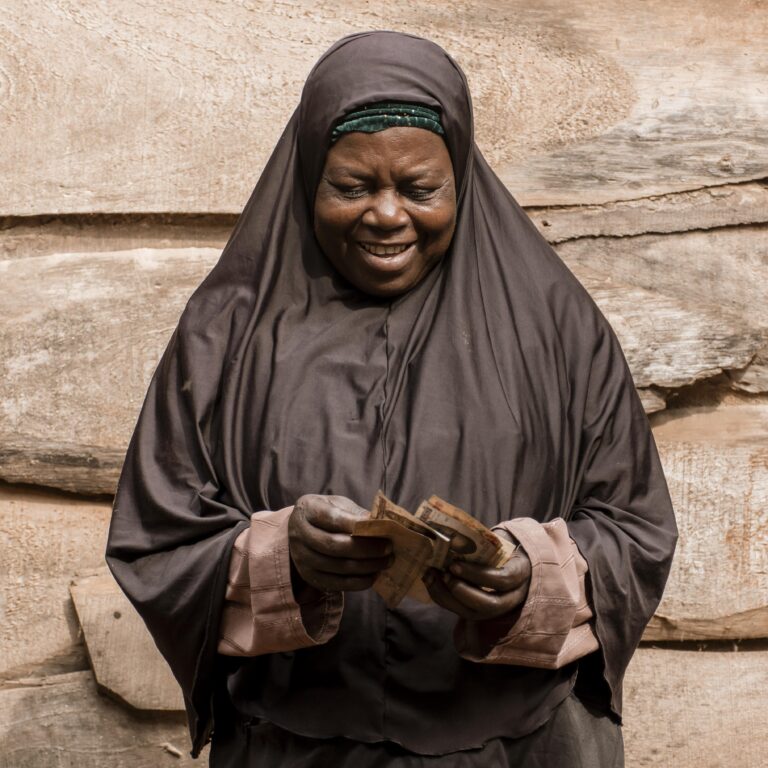 medium-shot-african-woman-holding-money